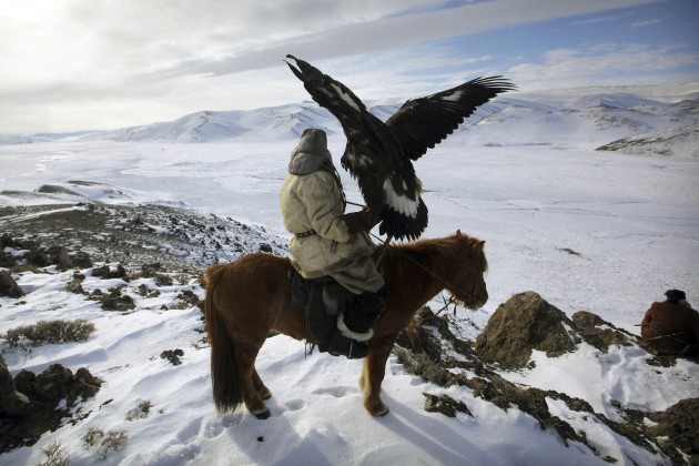 Kazakh Golden Eagle hunter on horseback. © Timothy Allen/Getty Images