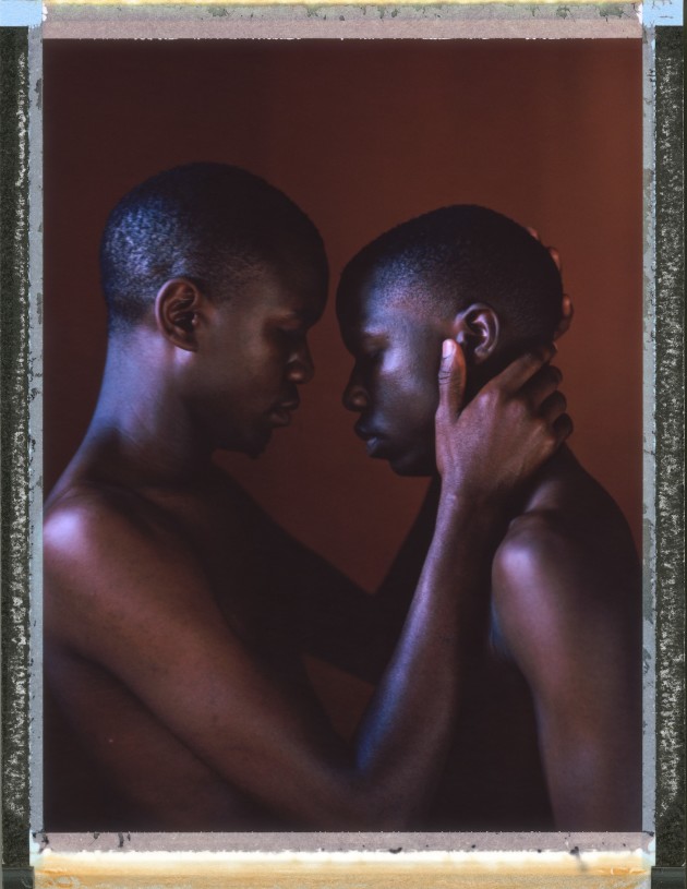 A posed portrait of Miiro (25) and Imran (21, not his real name), a gay couple living together in Uganda, from the series, 
