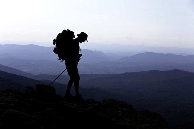 © Male Backpacker on Mountain Peak.© Christine Glade/Getty Images