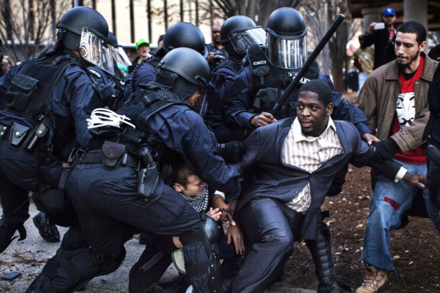 Bishop Derrick Robinson was arrested by riot police while protesting in a public park after a non-violent march, in Ferguson, Missouri, 30 November, 2014. © Natalie Keyssar.