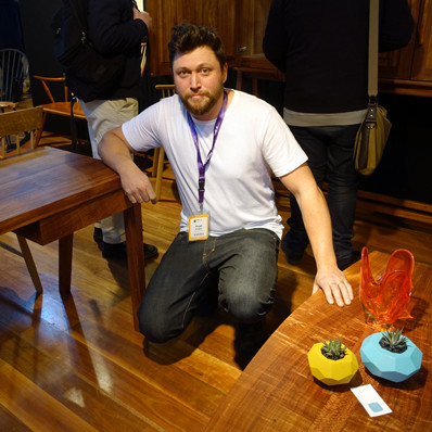 Hugh Makin, bespoke maker from Castlemaine, by his blackwood low table as he leans on his mid-century sideboard.