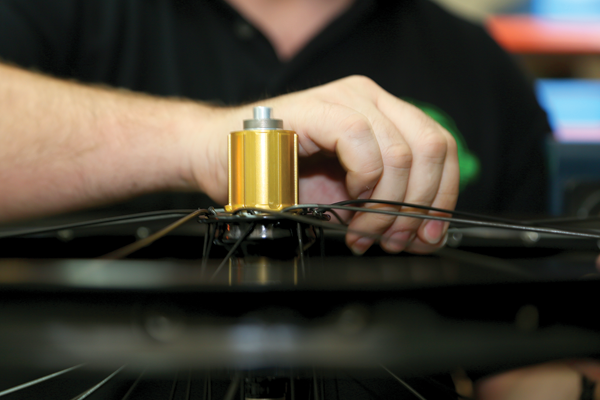 Wheels are laced by hand before being tensioned by this machine. They are then checked, trued and finished by hand.