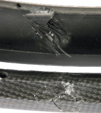 Both of these road rims were subjected to a similar impact. While both sustained damage the rim with the woven finish held together better.