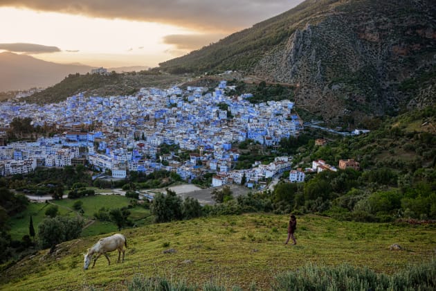 Morocco. There is a poetic story likening this blue city to the skies or heaven. Viewing the town at night from further away provides a magical vantage point where the warm-hued lights give a nice contrast to the blue-painted city. ©Steve McCurry/Vacheron Constantin