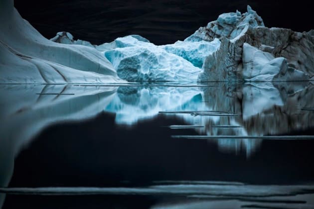 A quiet night on Ellesmere Island, in twenty-four hours of daylight. The high density of the cold water coupled by the high mass of its salt content makes for mirror-like reflections. Ellesmere Island, Canadian Arctic, 2008. © Sebastian Copeland.