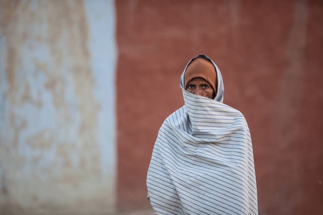 Chandelao, Rajasthan, India. It’s all about the eyes – if you can capture those well, then you have done half the work. This man was watching my progress as I explored the backstreets of a village while the sun was setting; he just stood there, wrapped in his blanket and stared. Looking back I saw a nice ochre-coloured mud wall behind him and figured that it would make a good background if I could eliminate any other distractions.
Because he was about ten metres in front of the wall I used a long lens to dramatically compress the perspective and throw the wall out of focus. By small adjustments of my own position I was able to position his eyes and the wall edge in the frame on the exact thirds intersection, as per classical composition guidelines. His eyes never left me and his piercing gaze is the centrepiece of this shot.
Canon EOS 5D Mark II, 300mm lens, 1/640s @ f2.8, ISO 1600.