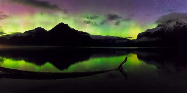 Aurora borealis flickers above Lake Minnewanka near Banff. Canon EOS 5D MKIV, 16-35mm f4 lens, 10s @ f/4, ISO 6400, tripod with Sunway panning clamp. Nine horizontal images stitched. Panorama stitching, colour and contrast adjustments in Lightroom CC and Adobe Photoshop CC.