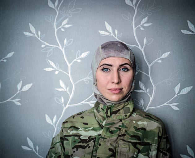 July 2015, Odessa. Amina Okuyeva poses for the photo in a flat she shares with her mother and son. Amina left war-torn Chechnia and moved to Odessa where she studied and become a doctor. She was on Maidan from December 2014 working as a medical volunteer. In that time her husband was in prison accused of the attempt to kill Russian President V. Putin. After Euromaidan revolution he was pardoned and together with Amina joined 