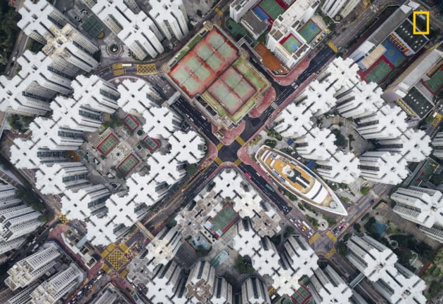 Photo and caption by Andy Yeung/National Geographic Travel Photographer of the Year. 2nd Place, Cities: Walled City #08
The Kowloon Walled City was the densest place on Earth. Hundreds of houses stacked on top of each other enclosed in the center of the structure. Many didn’t have access to open space.This notorious city was finally demolished in 1990s. However, if you look hard enough, you will notice that the city is not dead. Part of it still exists in many of current high density housing apartments. I hope this series can get people to think about claustrophobic living in Hong Kong from a new perspective.