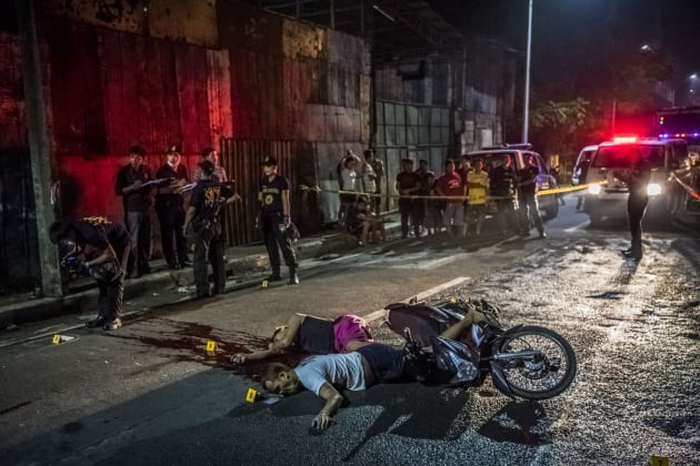 Crime-scene investigators gather evidence after Frederick Mafe and Arjay Lumbago were gunned down by unidentified motorcyclists in Manila.