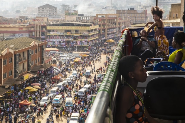 © Federico Redin, Beauty Centre, Uganda. A hairdresser works on the balcony of a commercial building while her clients relax. Competition for trading space in central Kampala is fierce.