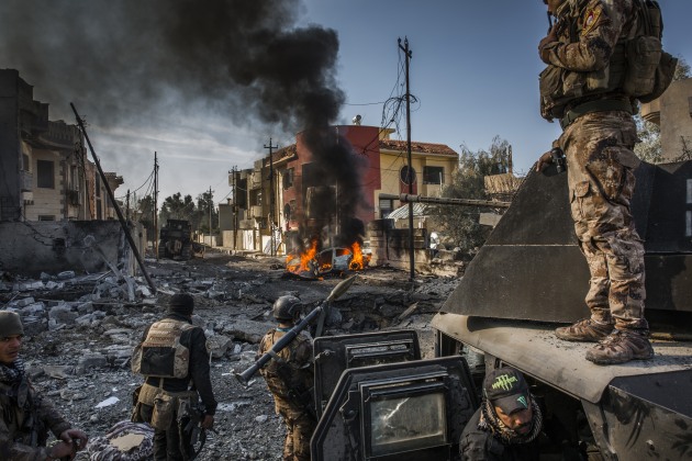 Iraqi Special Forces soldiers surveyed the aftermath of an ISIS suicide car bomb that managed to reach their lines in the Al Andalus neighbourhood of East Mosul. January 2017. Ivor Prickett for The New York Times.
