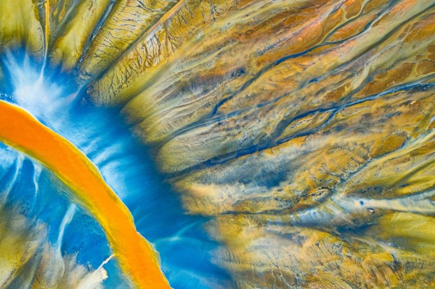 © Gheorghe Popa. Poisoned River. This is a detailed photograph of one of the small rivers filled with poison. “Poisoned Beauty” is a personal project that tells the story of the natural disaster in the “Apuseni Mountains”, but in a beautifully abstract way. This abstract colorful pattern is created by nature combined with the chemical waste resulted from the copper and gold mining process.