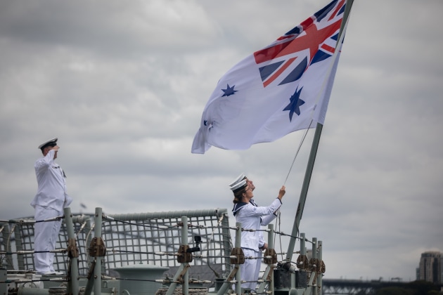 Able Seaman Communication and Information Systems Samuel Millar and Able Seaman Communication and Information Systems Alice Saunders lower HMAS Darwin’s Australian White Ensign for the last time. Defence