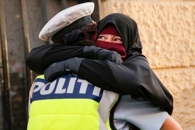 © Andrew Kelly , Australia, Shortlist, Professional, Documentary, 2019 Sony World Photography Awards.
Ayah, 37, (R) and wearer of the niqab weeps as she is embraced by a police officer during a demonstration against the Danish face veil ban in Copenhagen, Denmark, August 1, 2018.
On May 31, 2018, the Danish government voted to ban the wearing of face veils in public. Under the law, police will be able to instruct women to remove their veils or order them to leave public areas. Fines will range from 1,000 to 10,000 crowns ($160 - $1600).. The ban would prevent Muslim women from wearing the niqab or burqa in public. Some politicians asserted that the law promoted public safety and secular and democratic values. But many people felt it was an easy way for the government to appease a growing nationalist voter base.