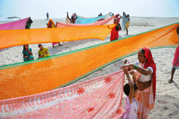 Drying Saris on the Banks of the Ganges. An image from the essay “India in an Ambassador”, a trip around a little of India in an 
iconic Hindustan Ambassador taxi, which was based on the 1950s Morris Oxford, before the production line closed in 2014. Image made on the banks of Mather Ganga at Varanasi. Nikon D3S, Nikkor 28-300mm lens @ 28mm. 1/640s @ f6.3, ISO 200.