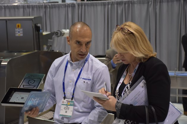 Multivac product manager Cem Yildirim runs through the features of the equipment on display at Pack Expo with PKN editor Lindy Hughson.