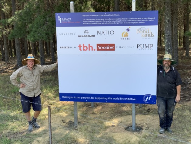 Sign of positive change: Impact International MD Aleks Lajovic (left) and engineering manager, Stuart Hunt with the newly erected signage showing brand partners in the sustainable forest initiative.