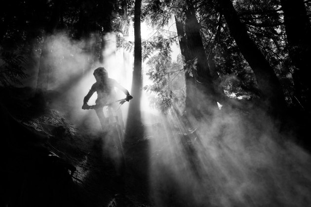 WINNER of RAW by Leica: Bruno Long (Canada). Local rider, Dylan Siggers, speeds through a forest trail in Fernie, BC, Canada. Image: Bruno Long / Red Bull Illume