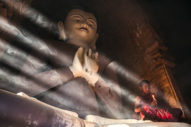 A novice monk poses for a portrait inside a temple in Bagan, Myanmar. Sidelight through a nearby window helped define the incense smoke to capture a surreal environmental portrait.
Canon 6D, Canon 16-35mm f/2.8 lens @ 32mm. 1/30s @ f2.8, ISO 500, tripod. Contrast, saturation and white balance adjusted in Adobe Lightroom CC.