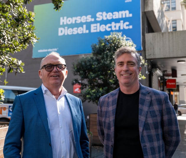 Offsetting carbon in banners: SCG co-managing director Fred Soar (left) and Go Media general manager Simon Teagle in front of a billboard for which Go Media has paid for the carbon offset