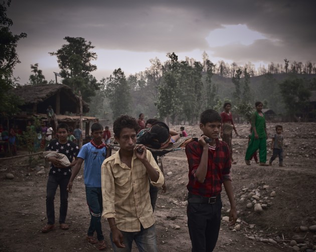 Category: Hidden Worlds. © Poulomi Basu. Blood Speaks, Surkhet district, Nepal, 2016. Saraswati, a 16-year-old new mother, is being carried from her village to the nearest hospital – a three-hour journey that will involve a river crossing. Because of her post-partum bleeding her community deemed her impure, and she was shut inside a small, darkened room, an exile intended to last for 15 days. As a result, her legs are now severely swollen and she also has post-partum depression.