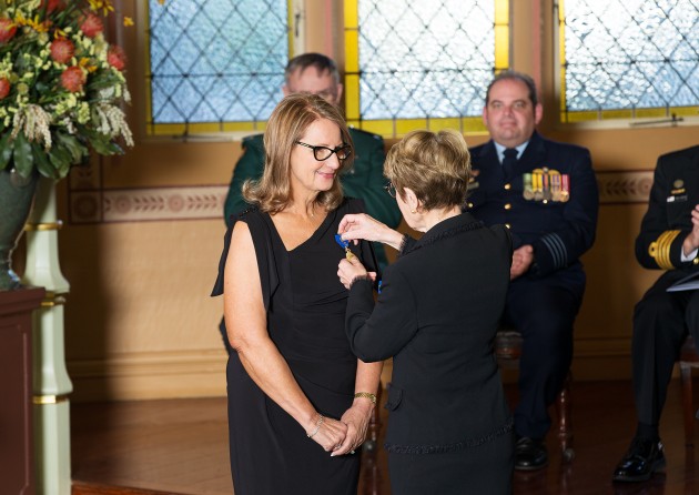 Governor Beazley invests Nadia Taylor as a Member of the Order of Australia (AM).
