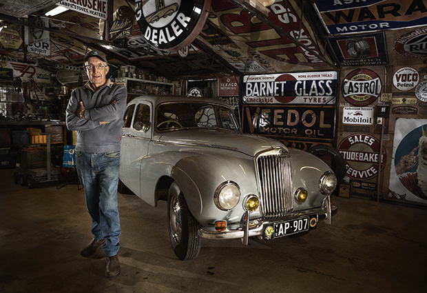 Darryl Williamson is an avid sign collector. He also restored the pictured Sunbeam-Talbot 90 4-Door Saloon 1948. Darryl was photographed for the Men's Sheds project by Craig Wetjen.