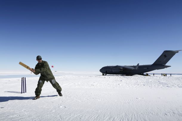 Leading Aircraftman Reece Pilgrim of No 36 Squadron plays cricket on the snow at Wilkins Aerodrome. Credit: Defence