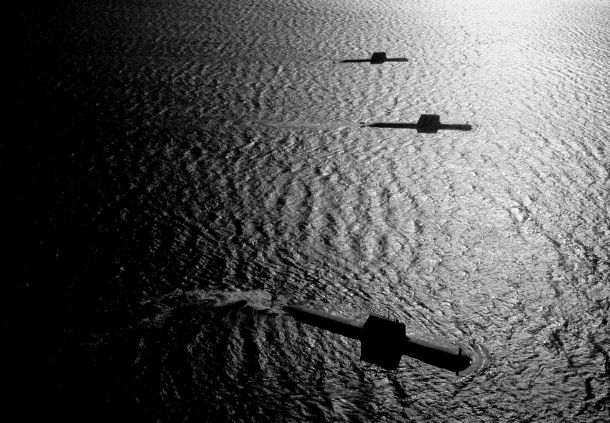 Collins class submarines conduct surface manouevres during a "photex". Credit: Defence