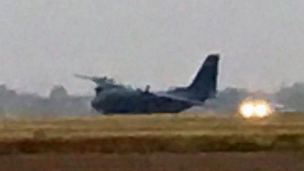 A RAAF C-27J Spartan on its side having reportedly blown two tyres after landing short of the runway. Credit: Paul J. Gately