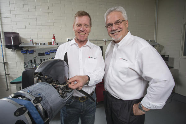 Orbital UAV head of engineering John Tubb (L) and CEO and MD Terry Stinson with an N20 propulsion unit destined for an Insitu ScanEagle UAV. Credit: Orbital