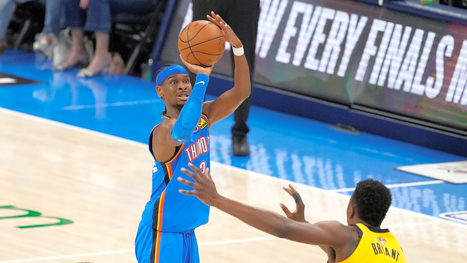 Oklahoma City Thunder guard Shai Gilgeous-Alexander has his hands up in motion for a jump shot while Indiana Pacers center Thomas Bryant moves forward to guard him