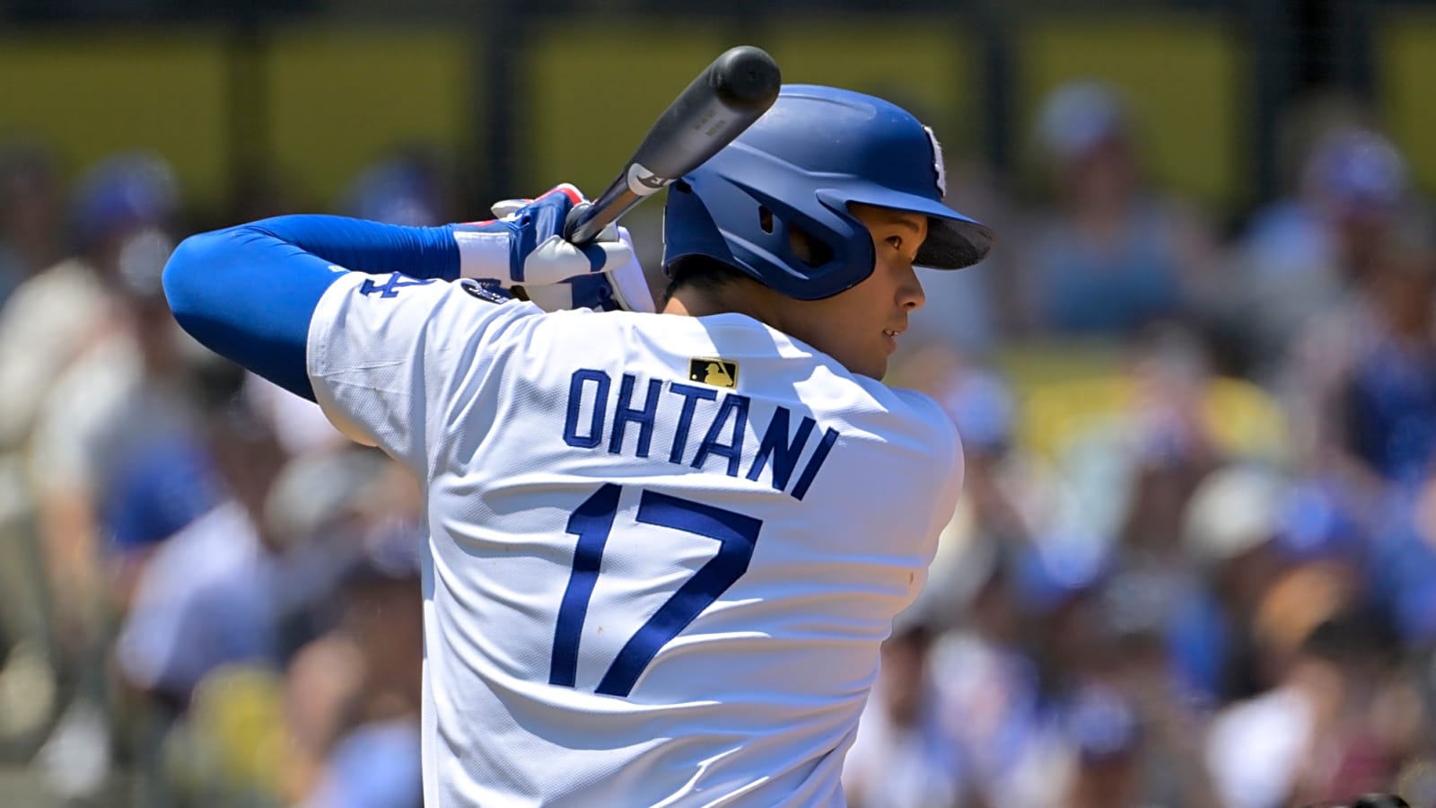 Los Angeles Dodgers designated hitter Shohei Ohtani with the bat poised behind him as he stands ready behind home plate