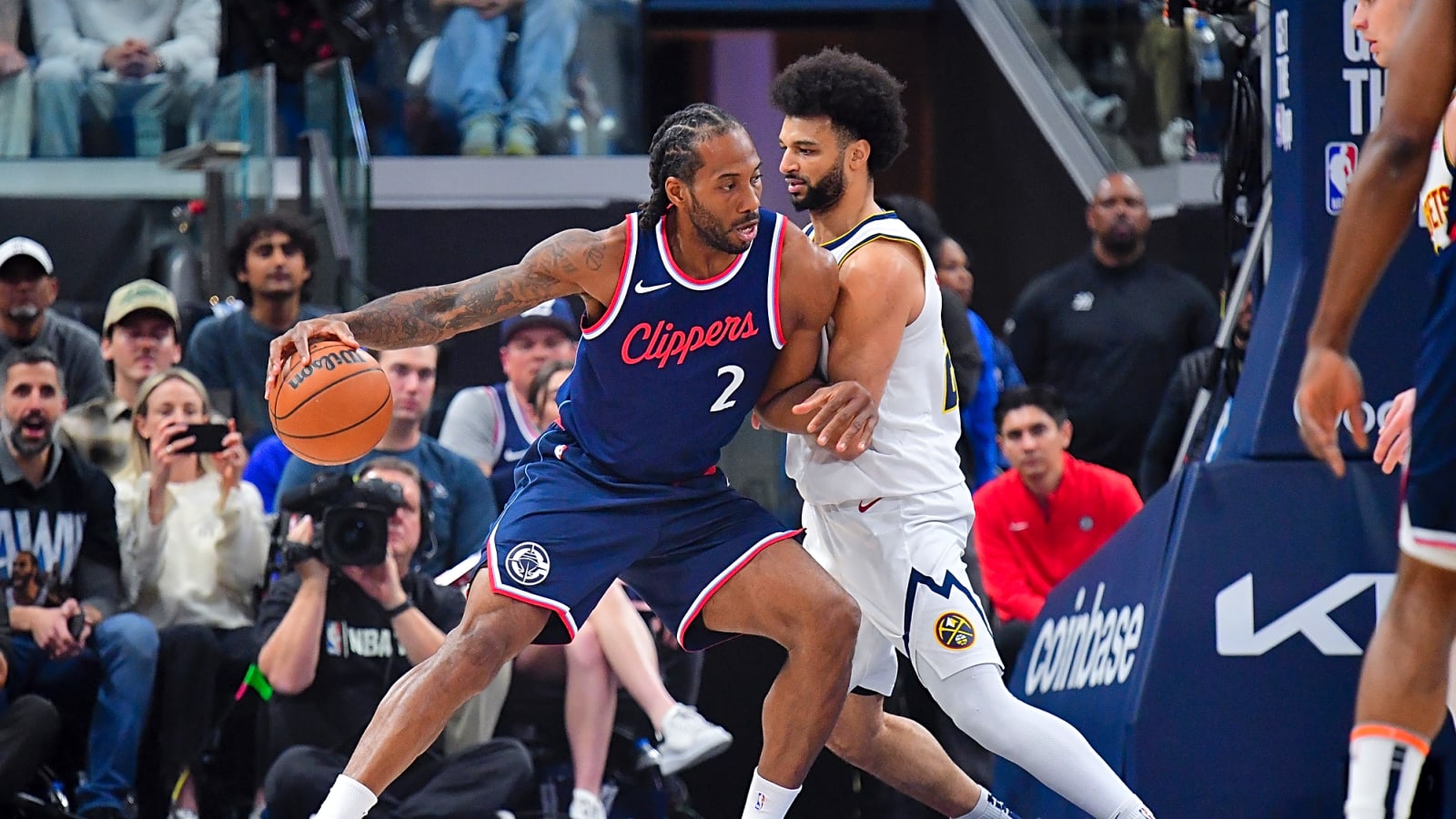 Clippers' Kawhi Leonard drives into Nuggets' Jamal Murray with the ball in his right hand for Game 3 of the 2025 NBA first round playoff series