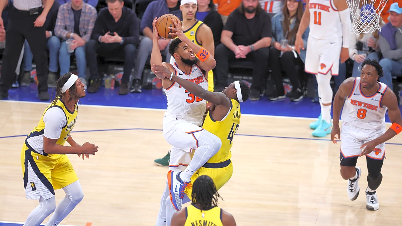 New York Knicks center Karl-Anthony Towns (32) shoots against Indiana Pacers forward Pascal Siakam (43) as KAT leaps into the air pushing Siakam
