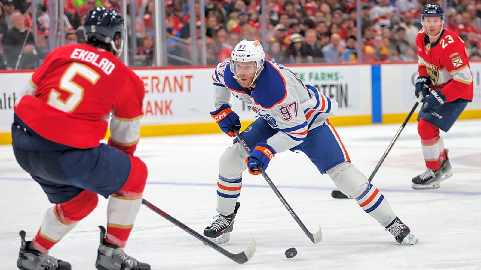 Edmonton Oilers center Connor McDavid (97) moves the puck as Florida Panthers defenseman Aaron Ekblad exhibits his backchecking prowess