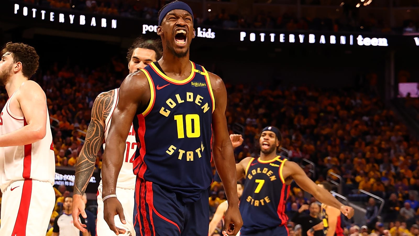 Golden State Warriors Jimmy Butler yelling with his mouth open with arms flexed at his sides