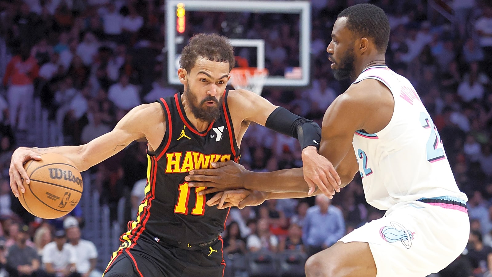 Heat's Andrew Wiggins defends Hawk's Trae Young in second half at Kaseya Center in a March 2025 matchup