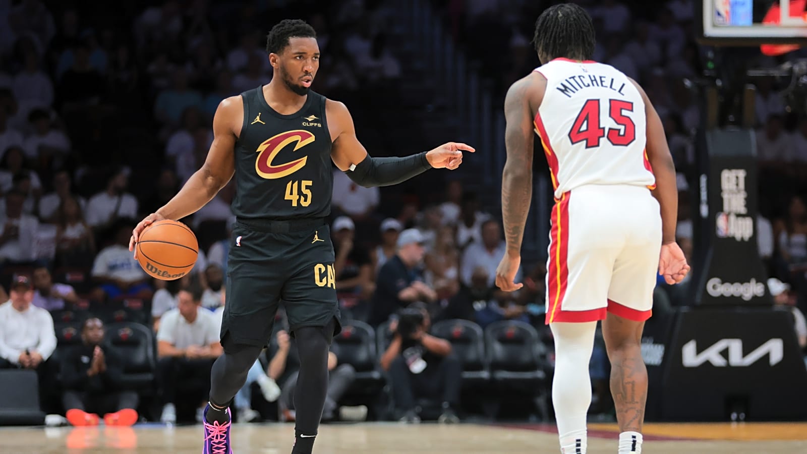 Cleveland Cavaliers guard Donovan Mitchell (45) dribbles the basketball in his right hand while pointing to the left
