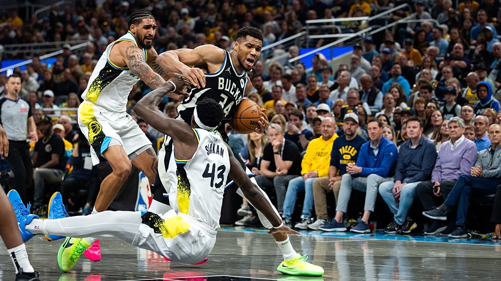 Milwaukee Bucks forward Giannis Antetokounmpo pushes past Pacers forward Pascal Siakam who has fallen to the floor in the NBA 2025 Playoff series