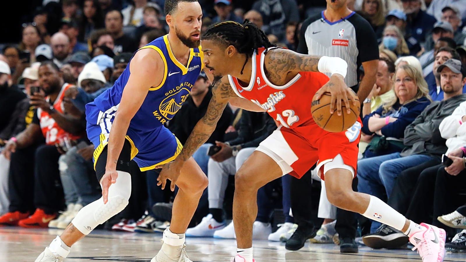 Ja Morant dribbles toward Stephen Curry defending the star Grizzlies player in Memphis