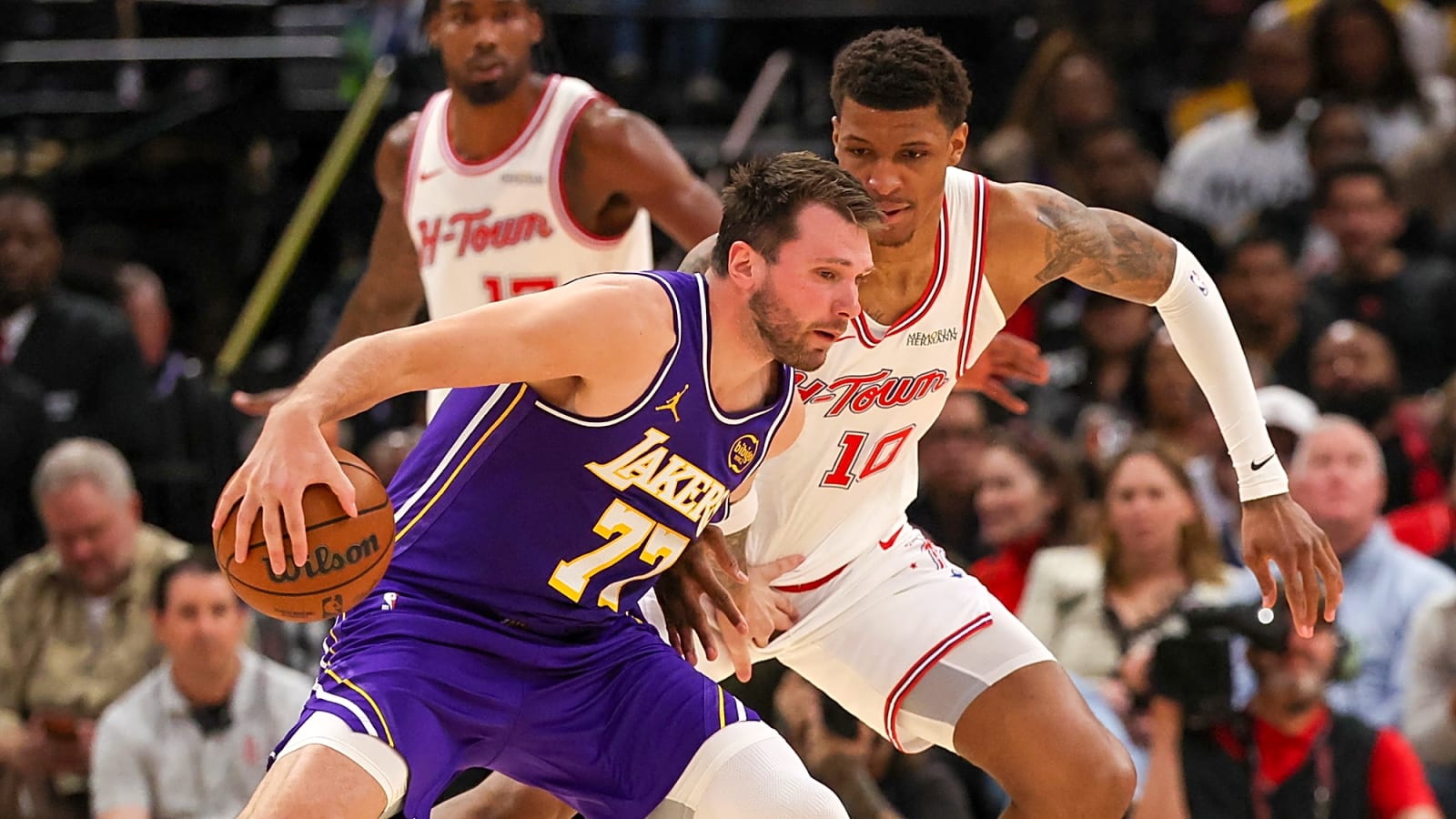 Luka Doncic trash talks a Rockets fan in the middle of live play