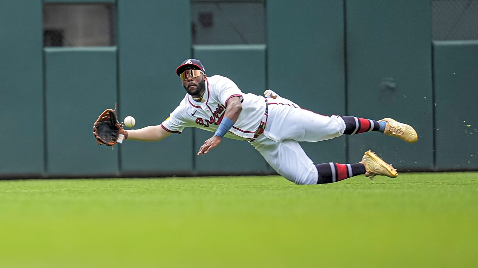Atlanta Braves outfielder Michael Harris II (23) suspended in air above the ground diving as the ball enters his glove