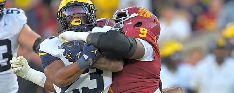 Handing out game balls in the Washington vs. Michigan game