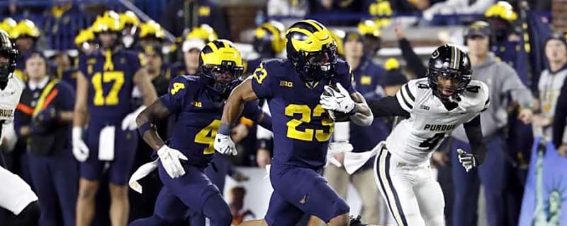 Handing out game balls in the Purdue vs. Michigan game