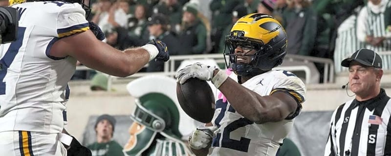Justice Haynes (2 TDs), carries No. 25 Michigan past Michigan State