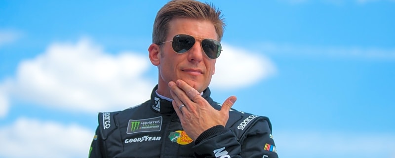 Jamie McMurray holds, bottle-feeds baby kangaroo during NASCAR race at Texas Motor Speedway
