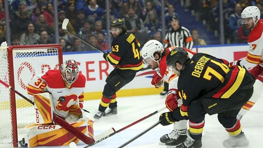 Flames score 5 consecutive goals to surge past Canucks