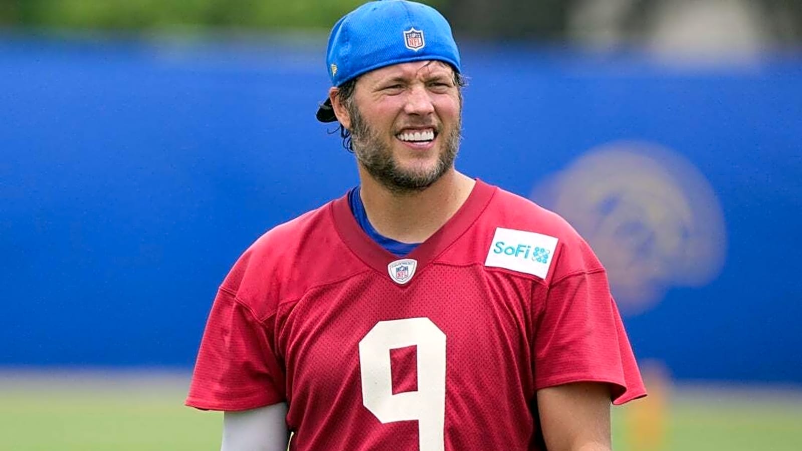 Rams QB Matthew Stafford (back) participates in first practice